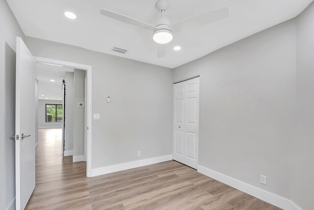 empty room featuring light wood-type flooring and ceiling fan