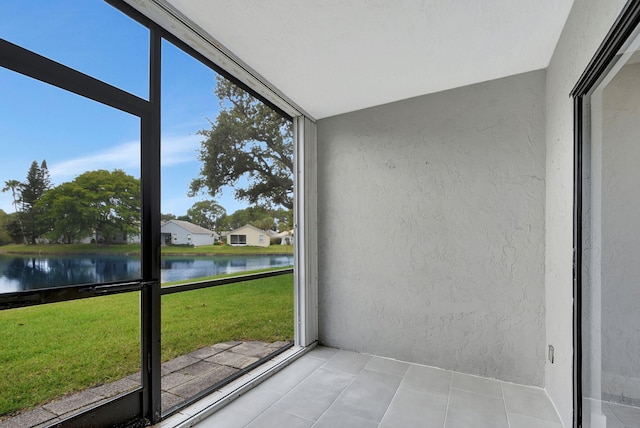 unfurnished sunroom with a water view