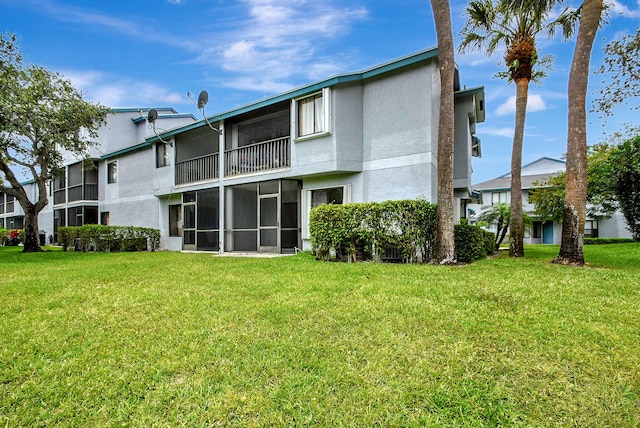 rear view of property featuring a lawn