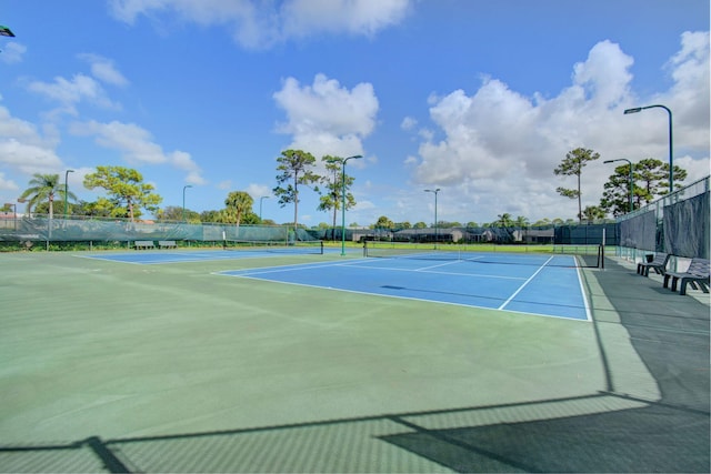 view of tennis court with basketball hoop