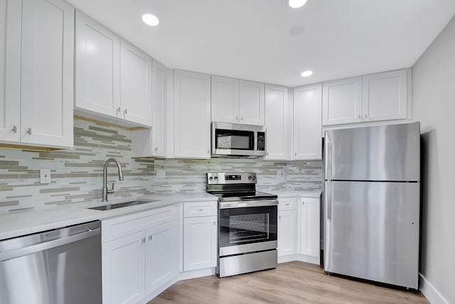 kitchen with sink, white cabinets, and stainless steel appliances