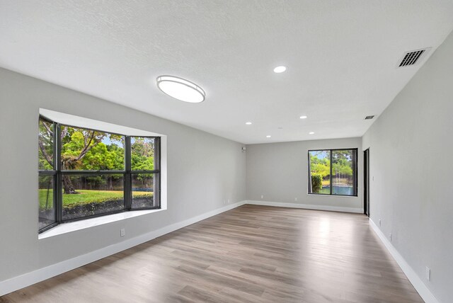 kitchen with white cabinets, sink, light wood-type flooring, tasteful backsplash, and stainless steel appliances