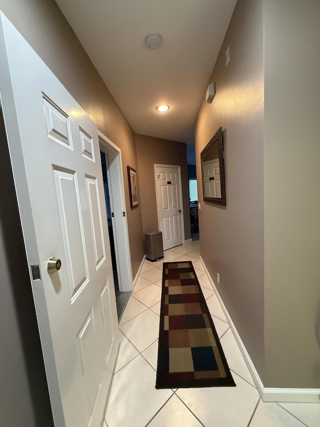 hall featuring light tile patterned floors