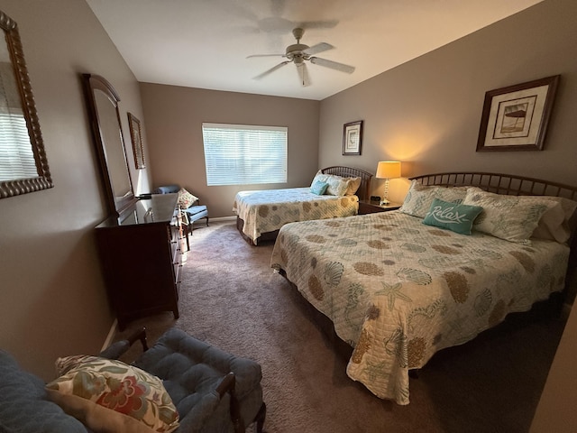 bedroom featuring ceiling fan and dark carpet