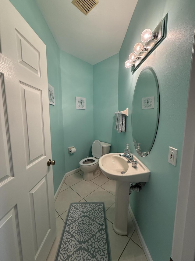 bathroom featuring toilet and tile patterned floors