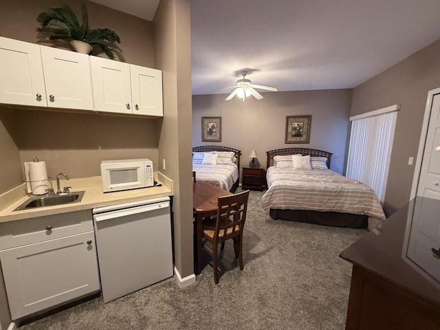 bedroom featuring ceiling fan, sink, and dark carpet