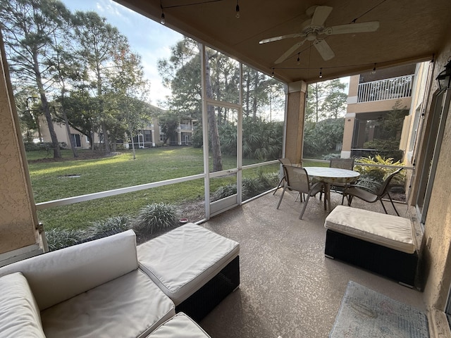 sunroom / solarium featuring ceiling fan