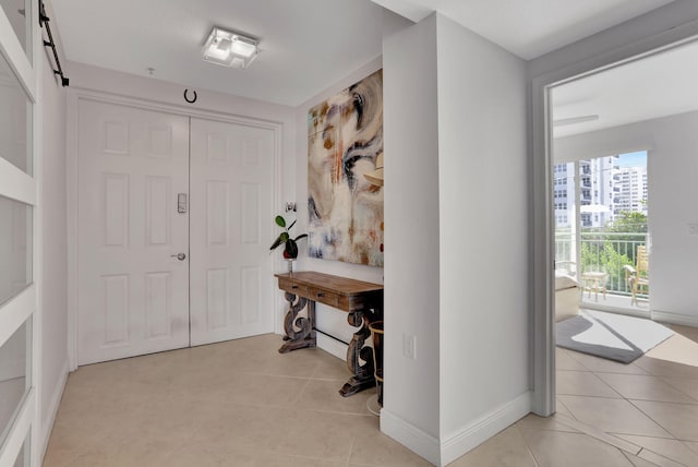 tiled entryway featuring a barn door