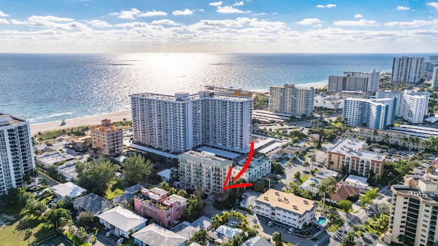 aerial view with a water view and a beach view