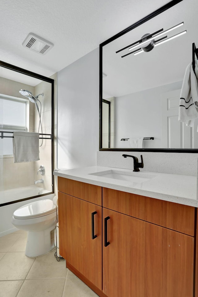 full bathroom with toilet, tile patterned flooring, vanity, and tiled shower / bath