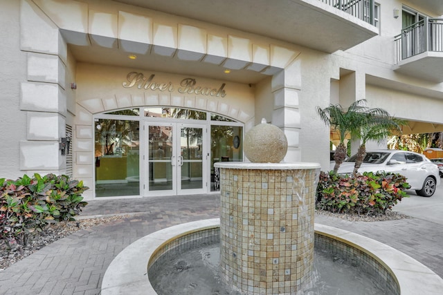 view of exterior entry featuring french doors