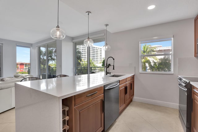 kitchen with decorative light fixtures, a healthy amount of sunlight, sink, and appliances with stainless steel finishes