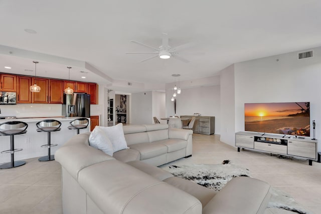 living room featuring ceiling fan and light tile patterned floors