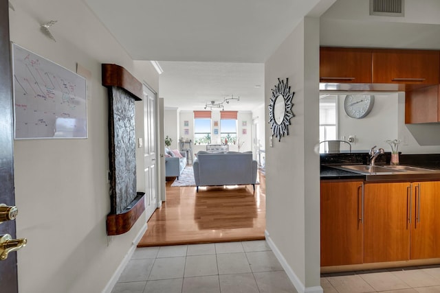 kitchen featuring light tile patterned flooring and sink