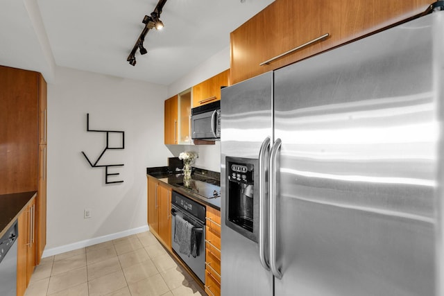 kitchen with light tile patterned floors, track lighting, and black appliances