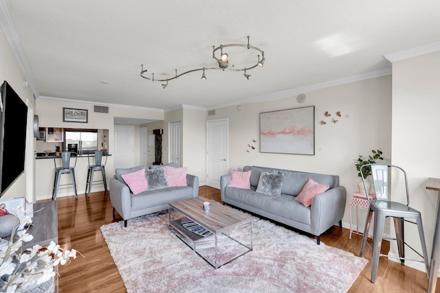 living room featuring hardwood / wood-style floors and ornamental molding