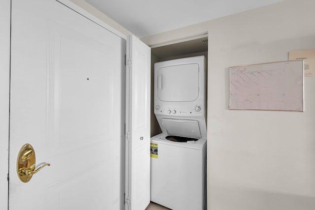 laundry area featuring stacked washer and clothes dryer