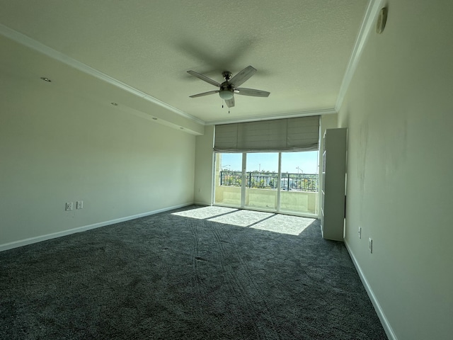 carpeted spare room featuring a textured ceiling, ceiling fan, and crown molding