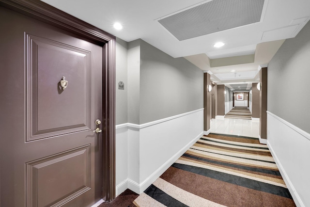 hallway featuring dark colored carpet