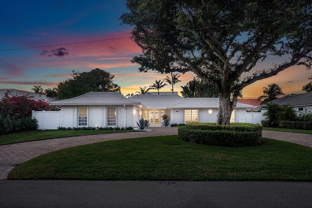 ranch-style home with a lawn