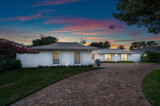 ranch-style home featuring a yard