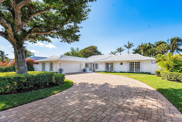 ranch-style house with a front lawn and a garage