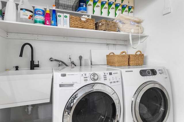 laundry area featuring washer and clothes dryer and sink