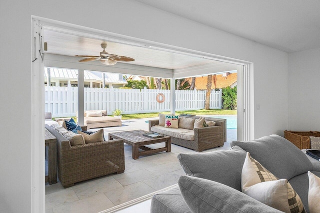 tiled living room with a wealth of natural light and ceiling fan