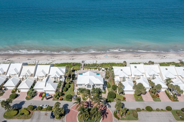 drone / aerial view featuring a beach view and a water view