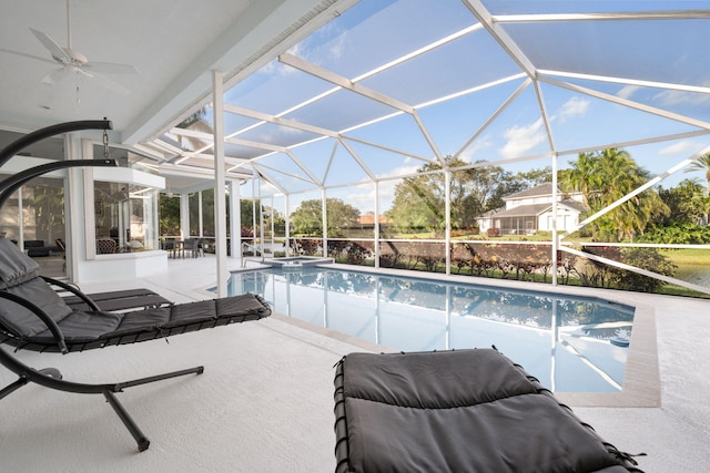 view of swimming pool featuring a patio, ceiling fan, and a lanai