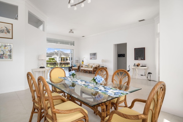 dining space featuring crown molding