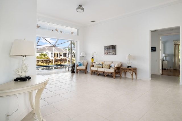 living room featuring light tile patterned floors and ornamental molding