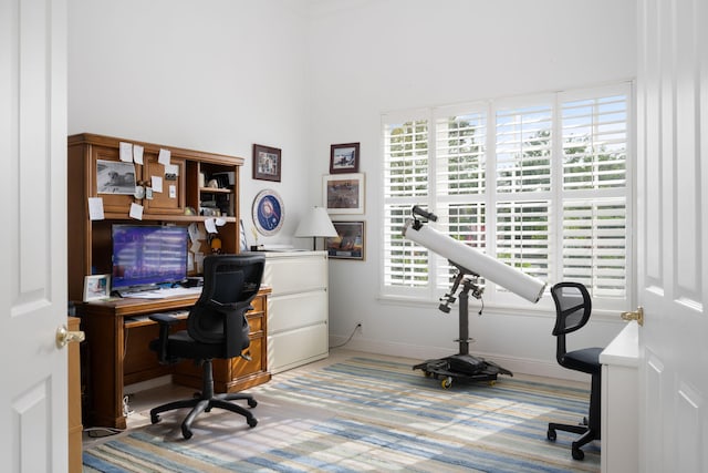 home office featuring carpet flooring and a healthy amount of sunlight