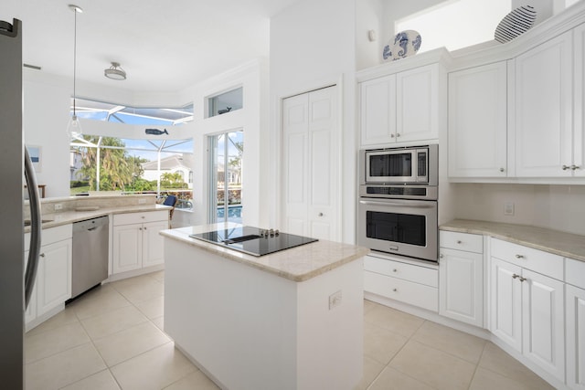 kitchen with a kitchen island, white cabinetry, and appliances with stainless steel finishes