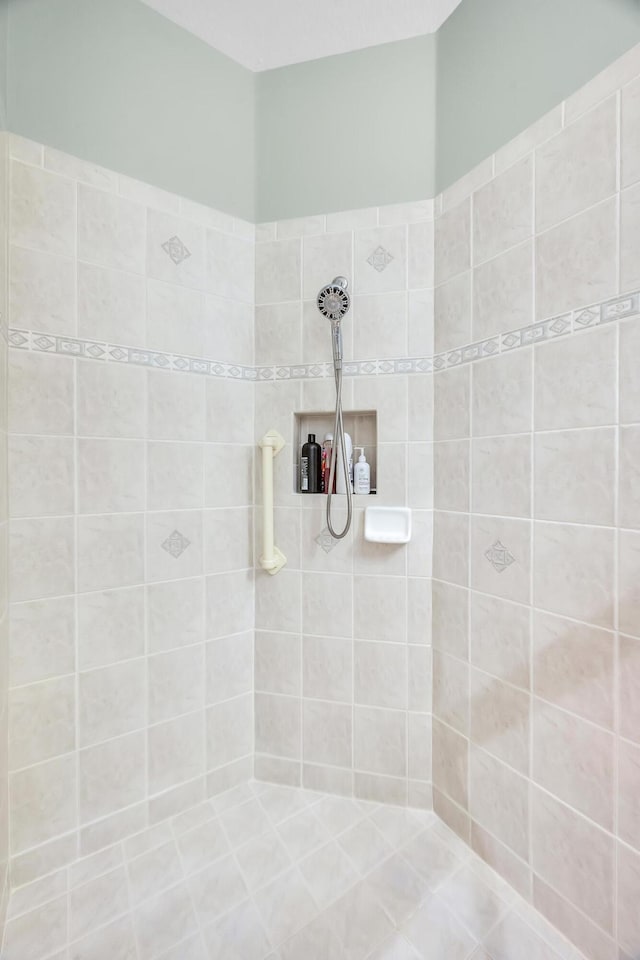 bathroom with a tile shower