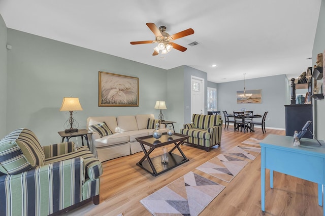 living room featuring light hardwood / wood-style floors and ceiling fan