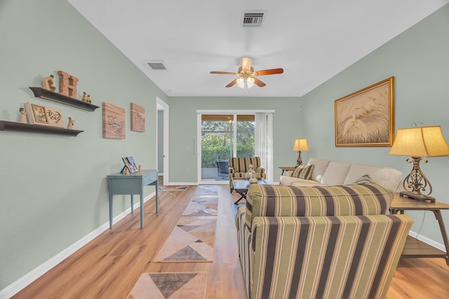 living room with ceiling fan and light hardwood / wood-style floors