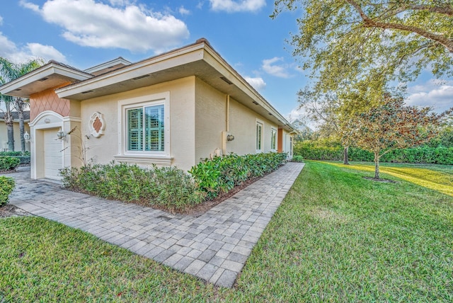 view of property exterior with a lawn and a garage