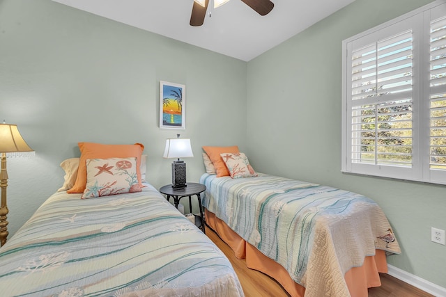 bedroom featuring wood-type flooring and ceiling fan