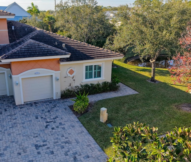 view of front of house with a front lawn and a garage