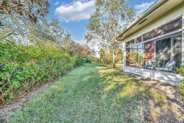 view of yard with a sunroom