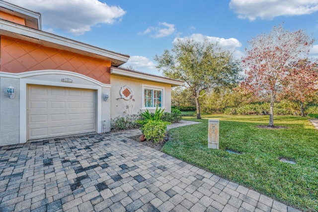 exterior space with a front yard and a garage