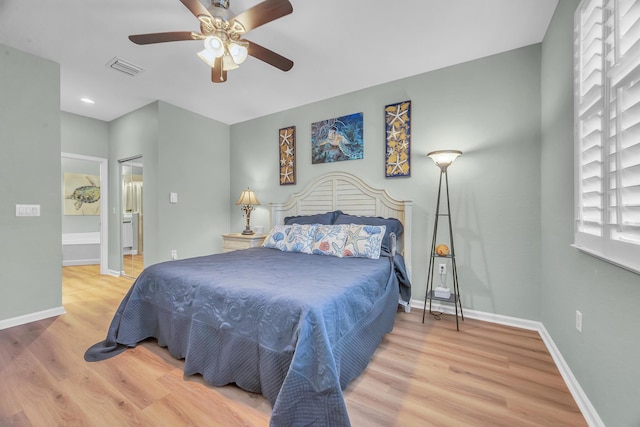 bedroom with hardwood / wood-style floors and ceiling fan