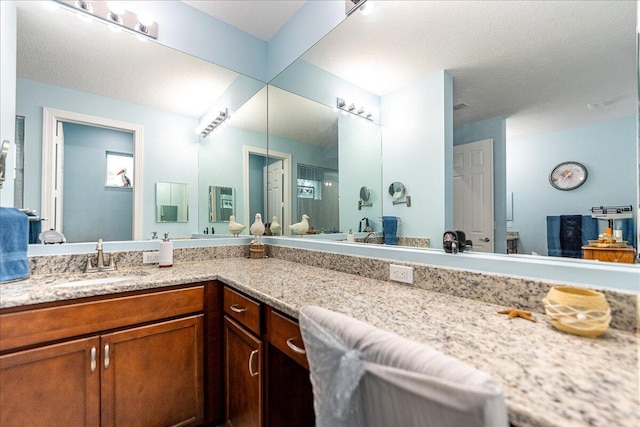 bathroom with a textured ceiling and vanity