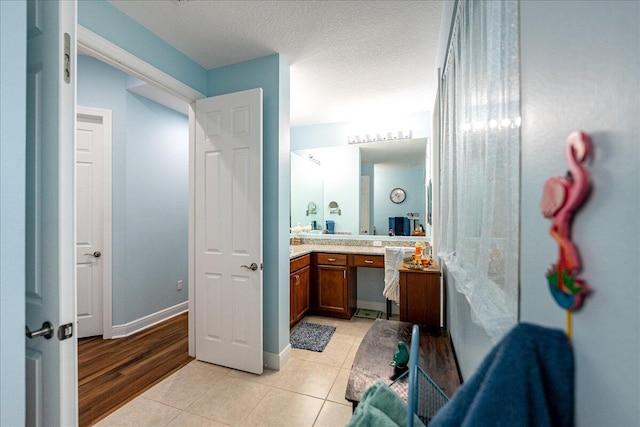 bathroom with vanity, tile patterned floors, and a textured ceiling