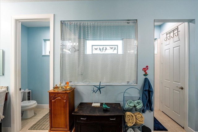 bathroom featuring toilet and tile patterned flooring