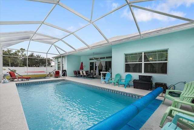 view of swimming pool with a lanai, a patio, and ceiling fan