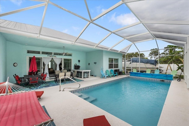 view of swimming pool with a patio area, a lanai, and ceiling fan