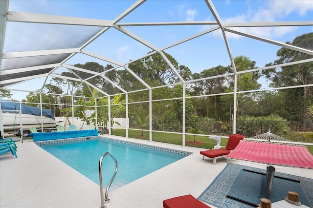 view of swimming pool with a patio and a lanai