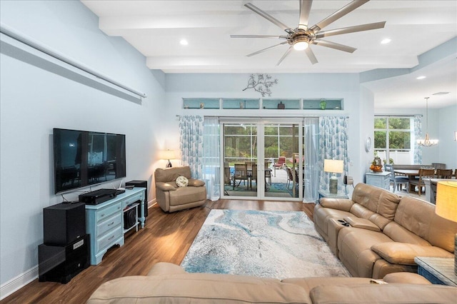 living room featuring dark wood-type flooring, ceiling fan with notable chandelier, and beamed ceiling